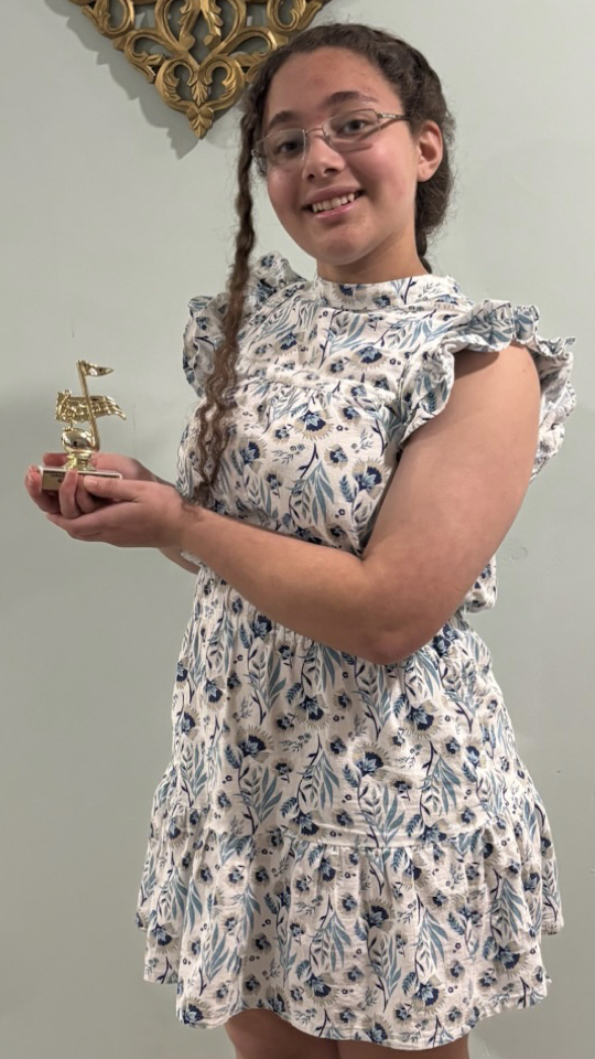 Student Isabella holding Trophy